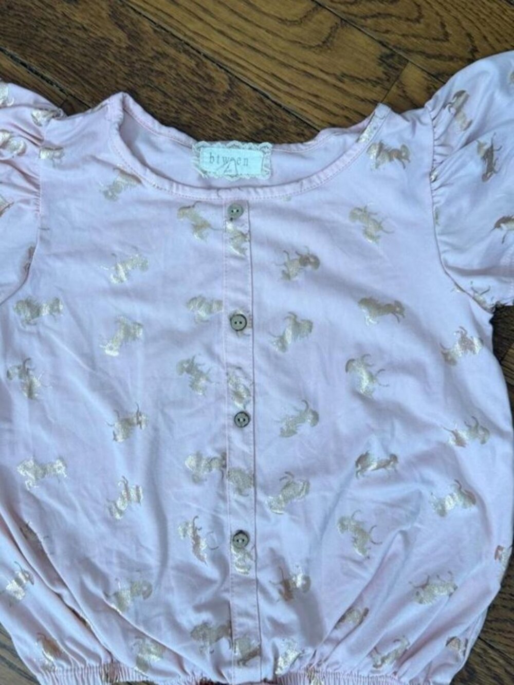 Btween girl’s Pink unicorn babydoll top with button up front and tie waist. Size